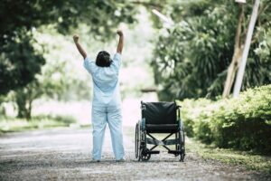 physical-therapy-senior-woman-with-wheelchair-park-min